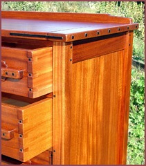 Drawer detail including through-dovetails construction and Ebony caps.